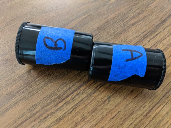 Two film canisters, labeled A and B